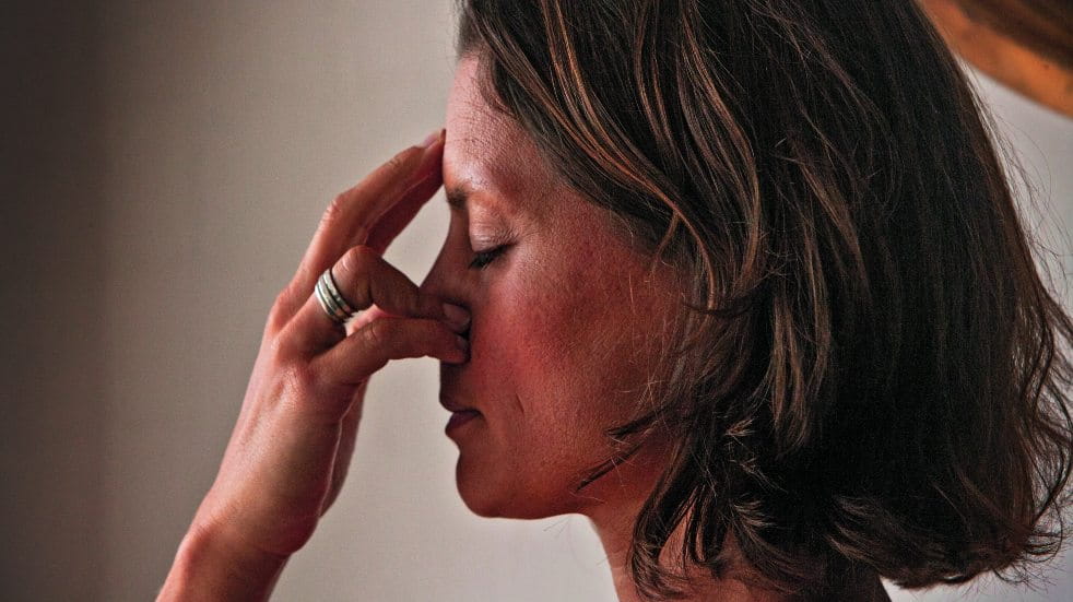 stressed woman holding face